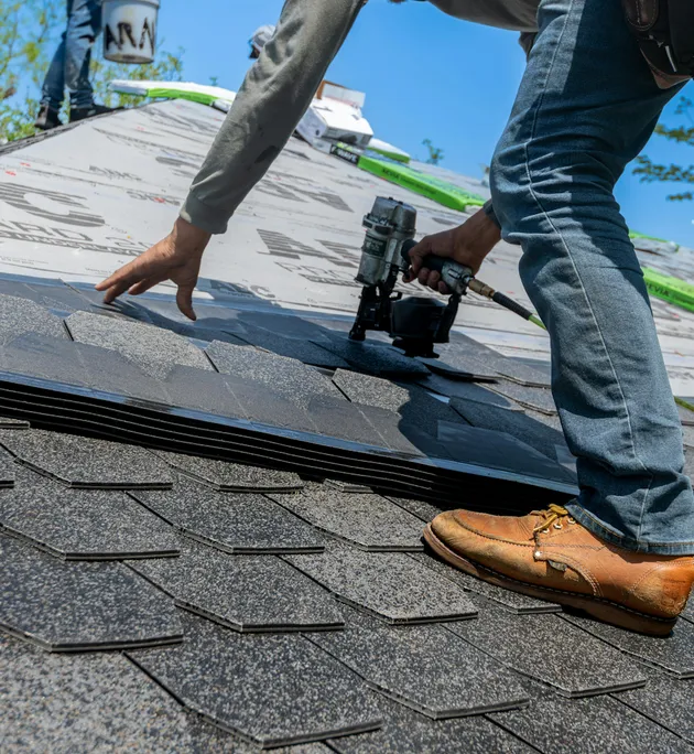 roofer installing shingles